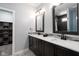 Modern bathroom with double vanity, sleek mirrors, and an open doorway to the shower at 2215 S Delaware St, Indianapolis, IN 46225