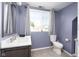 Bright bathroom with white marble countertops and gray accent walls, offering a modern and clean aesthetic at 2215 S Delaware St, Indianapolis, IN 46225