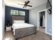 Serene bedroom with a tufted headboard and an en-suite bathroom with a tiled shower at 2215 S Delaware St, Indianapolis, IN 46225