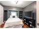 Cozy bedroom with a built-in storage nook and a sleek television console at 2215 S Delaware St, Indianapolis, IN 46225