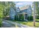 Angled view of a beautiful two-story home featuring a gravel driveway and manicured lawn at 2215 S Delaware St, Indianapolis, IN 46225
