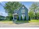 Charming two-story home with blue siding, manicured lawn, and symmetrical landscaping at 2215 S Delaware St, Indianapolis, IN 46225