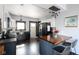 Renovated kitchen with stainless appliances, black refrigerator, island with seating, and new lighting at 2215 S Delaware St, Indianapolis, IN 46225