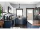 Updated kitchen featuring stainless steel appliances, navy cabinetry, and hardwood floors at 2215 S Delaware St, Indianapolis, IN 46225