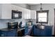 Remodeled kitchen with stainless steel appliances, stylish cabinetry, and stainless farmhouse sink at 2215 S Delaware St, Indianapolis, IN 46225
