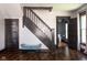 Foyer featuring a staircase with stylish dark wood and a cozy blue bench at 2215 S Delaware St, Indianapolis, IN 46225