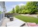 Well-manicured backyard featuring a concrete patio with lounge furniture and a plush green lawn at 2258 Bridlewood Dr, Franklin, IN 46131