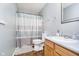 Standard bathroom featuring a toilet, sink, and a shower/tub combination with a blue striped shower curtain at 2258 Bridlewood Dr, Franklin, IN 46131