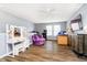 Bright bedroom featuring wood-look floors, a ceiling fan, and a comfortable sitting area, creating a cozy retreat at 2258 Bridlewood Dr, Franklin, IN 46131