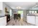 Cozy dining area features wood floors, neutral paint, modern light fixture, and sliding doors to the backyard at 2258 Bridlewood Dr, Franklin, IN 46131