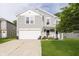 Charming two-story home featuring a two-car garage and a cozy front porch with seating area at 2258 Bridlewood Dr, Franklin, IN 46131
