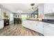 Spacious kitchen flowing into the dining area, with dark countertops and white cabinets at 2258 Bridlewood Dr, Franklin, IN 46131