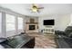 The living room offers a stone fireplace, a ceiling fan, and wood-look floors, creating a comfortable space at 2258 Bridlewood Dr, Franklin, IN 46131