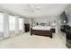 Spacious main bedroom with plush carpeting, a ceiling fan, and abundant natural light from the large windows at 2258 Bridlewood Dr, Franklin, IN 46131