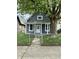 Charming single-story home with a fenced yard and a mature tree at 23 S Holmes Ave, Indianapolis, IN 46222