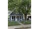 Charming single-story home with a fenced yard and a mature tree at 23 S Holmes Ave, Indianapolis, IN 46222