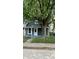 Charming single-story home with a fenced yard and a mature tree at 23 S Holmes Ave, Indianapolis, IN 46222