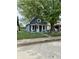 Charming single-story home with a fenced yard and a mature tree at 23 S Holmes Ave, Indianapolis, IN 46222