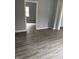 Living room with updated gray walls, white trim and updated flooring at 23 S Holmes Ave, Indianapolis, IN 46222