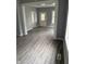 Open-concept living room featuring updated flooring, gray walls, and white trim and doors at 23 S Holmes Ave, Indianapolis, IN 46222