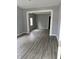 Open-concept living room featuring modern gray vinyl plank flooring and fresh paint at 23 S Holmes Ave, Indianapolis, IN 46222