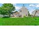 Expansive backyard with patio, wooden dining set, and vibrant green lawn, ideal for outdoor enjoyment at 237 Broadmoor Bnd, Pittsboro, IN 46167
