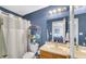 Cozy bathroom featuring a vanity sink, framed mirror, toilet, and shower with a white curtain at 237 Broadmoor Bnd, Pittsboro, IN 46167