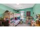Bright bedroom featuring a bunk bed, a window with striped curtains, and colorful decor at 237 Broadmoor Bnd, Pittsboro, IN 46167