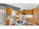 Well-lit kitchen featuring wood cabinets, white appliances, and a functional kitchen island at 237 Broadmoor Bnd, Pittsboro, IN 46167