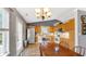 Bright eat-in kitchen with wood cabinets, stainless steel refrigerator, and hardwood flooring at 237 Broadmoor Bnd, Pittsboro, IN 46167