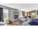 Inviting living room with a brick fireplace, plush seating, and abundant natural light at 237 Broadmoor Bnd, Pittsboro, IN 46167