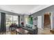 Cozy living room with hardwood floors, stairs, and a green front door adorned with a wreath at 237 Broadmoor Bnd, Pittsboro, IN 46167