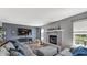 Comfortable living room features a brick fireplace, large TV, and neutral decor at 237 Broadmoor Bnd, Pittsboro, IN 46167