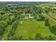 Lush green property with mature trees, outbuildings, and a well-maintained lawn at 2825 S State Road 267, Plainfield, IN 46168