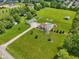 Beautiful aerial view of home with pool, large outbuilding, and spacious green lawn at 2825 S State Road 267, Plainfield, IN 46168