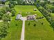 Expansive property featuring a well-maintained home, outbuildings, lush greenery, and ample space at 2825 S State Road 267, Plainfield, IN 46168