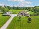 Breathtaking aerial view features the expansive estate, highlighting the lush lawn, detached garage, and serene surroundings at 2825 S State Road 267, Plainfield, IN 46168