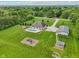 A sprawling backyard with a pool, pool house, play set, and mature landscaping at 2825 S State Road 267, Plainfield, IN 46168