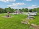 A sprawling backyard with a pool, pool house, play set, and mature landscaping at 2825 S State Road 267, Plainfield, IN 46168