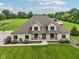 Aerial view of a beautiful home featuring lush green lawn, a well maintained landscape, and a brick facade at 2825 S State Road 267, Plainfield, IN 46168