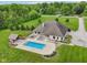 A sprawling backyard with a pool, pool house, and mature landscaping at 2825 S State Road 267, Plainfield, IN 46168