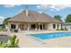 Lovely home's backyard and private pool surrounded by a large patio and lush greenery at 2825 S State Road 267, Plainfield, IN 46168
