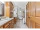 Bathroom with dual vanities, bathtub, and wooden cabinetry at 2825 S State Road 267, Plainfield, IN 46168