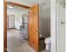 Bathroom featuring toilet, stand-up shower, wooden door, and open to kitchen at 2825 S State Road 267, Plainfield, IN 46168
