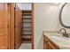 Bathroom featuring a granite vanity, a walk-in closet with shelving, and wood cabinets at 2825 S State Road 267, Plainfield, IN 46168