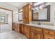 Bathroom with dual granite vanities and dark wood cabinetry at 2825 S State Road 267, Plainfield, IN 46168