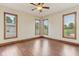 Bright bedroom with hardwood floors, large windows, and a ceiling fan at 2825 S State Road 267, Plainfield, IN 46168