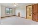 Bedroom featuring neutral carpet and trim, ceiling fan, and ensuite bath at 2825 S State Road 267, Plainfield, IN 46168