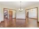 Open dining room with wood floors, chandelier, and wood-trimmed doorways at 2825 S State Road 267, Plainfield, IN 46168