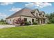 Side view of a house with a gravel driveway, lawn, and garage at 2825 S State Road 267, Plainfield, IN 46168